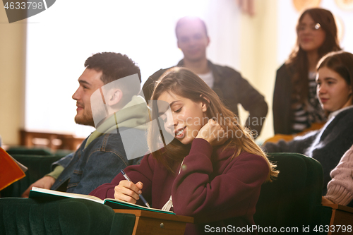 Image of The group of cheerful happy students sitting in a lecture hall before lesson