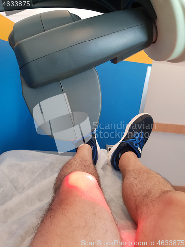 Image of Physical therapy using a laser to treat an injured knee