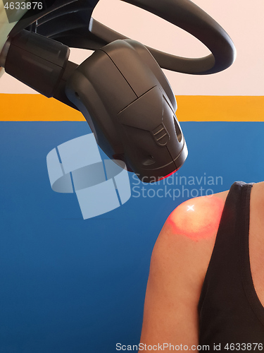 Image of Physical therapy using a laser to treat an injured shoulder