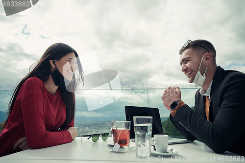 Image of business people wearing protective mask