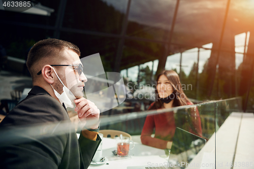 Image of business people wearing protective mask