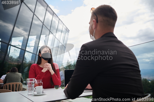 Image of business people wearing protective mask