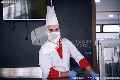 Image of chef cook wearing face protective medical mask for protection fr