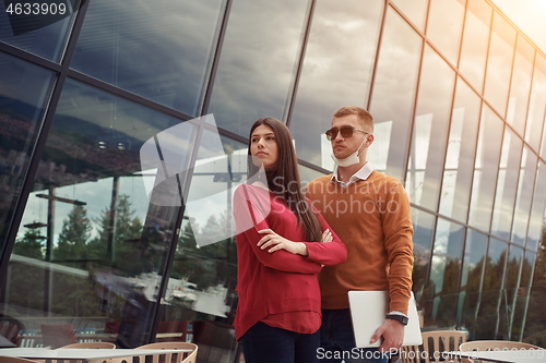 Image of business people wearing protective mask