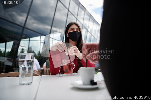 Image of business people wearing protective mask