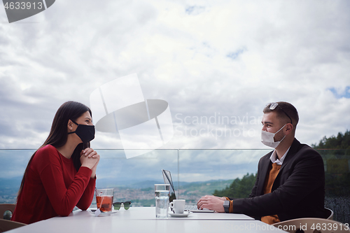 Image of business people wearing protective mask