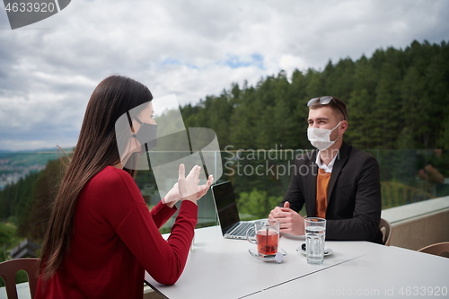 Image of business people wearing protective mask