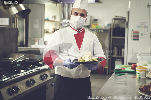 Image of chef cook wearing face protective medical mask for protection fr