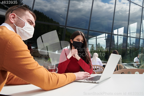 Image of business people wearing protective mask