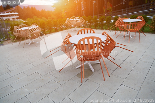 Image of restaurant tables and chairs at outdoor sitting at restaurant  d