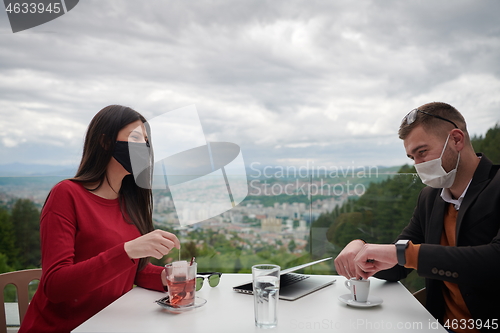 Image of business people wearing protective mask