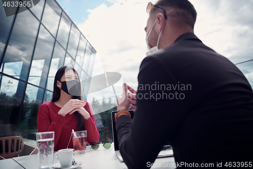 Image of business people wearing protective mask