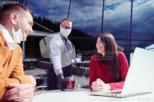 Image of business people wearing protective mask