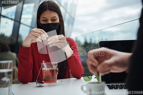 Image of business people wearing protective mask