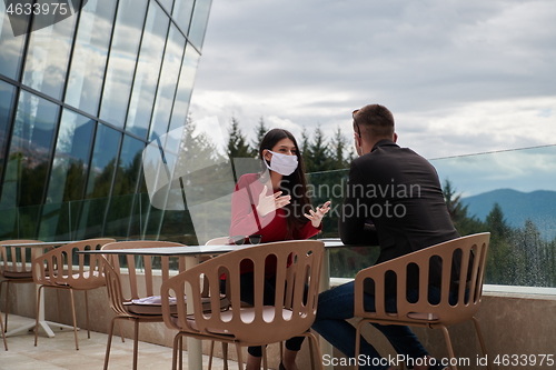 Image of business people wearing protective mask