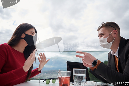 Image of business people wearing protective mask