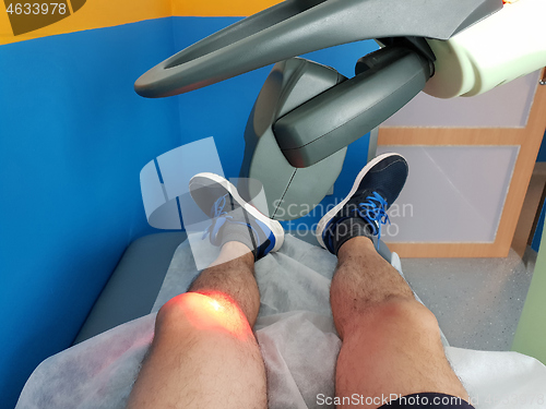 Image of Physical therapy using a laser to treat an injured knee