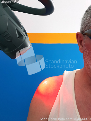 Image of Physical therapy using a laser to treat an injured shoulder