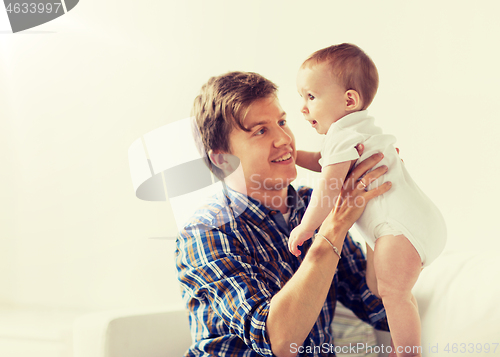 Image of happy young father with little baby at home