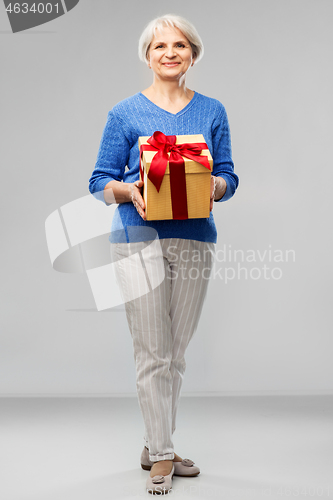 Image of happy smiling senior woman with birthday gift box