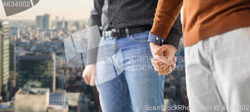 Image of close up of male gay couple holding hands