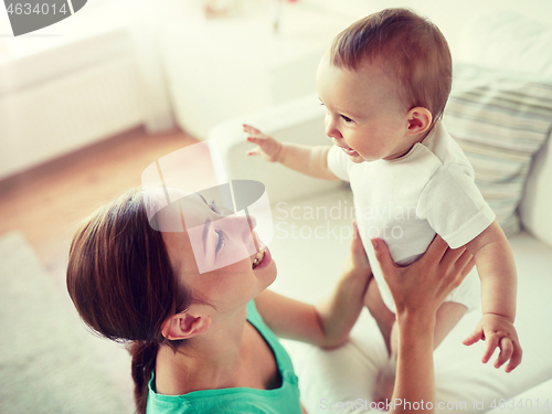 Image of happy young mother with little baby at home