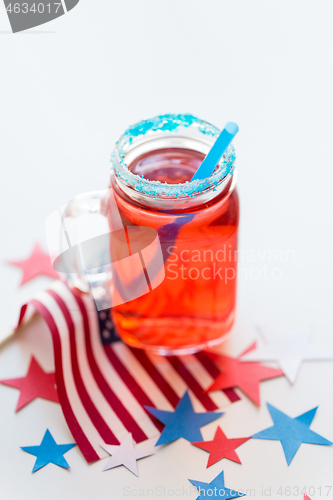 Image of mug of juice and american flag on independence day