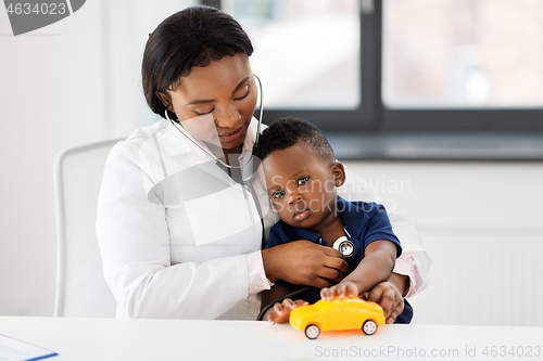 Image of doctor with stethoscope and baby patient at clinic