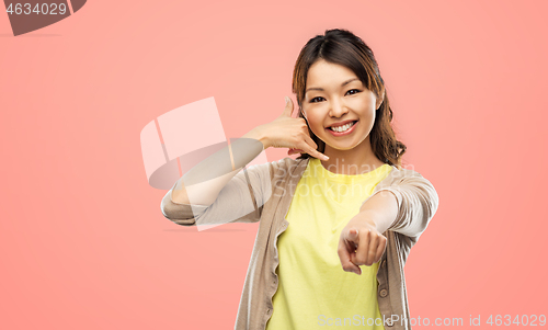 Image of african asian making phone call gesture