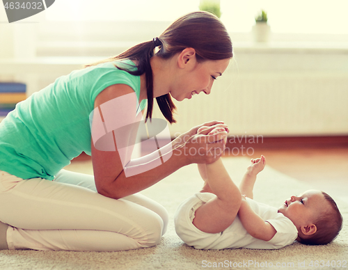 Image of happy mother playing with baby at home