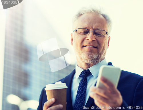 Image of businessman with smartphone and coffee in city