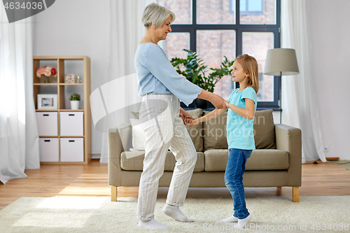 Image of grandmother and granddaughter having fun at home