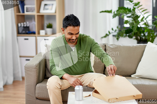 Image of indian man looking inside of takeaway pizza box