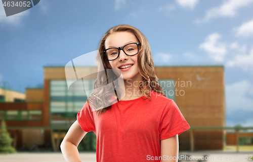 Image of smiling student girl in glasses over school