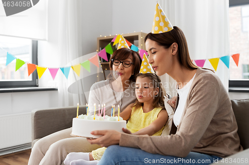 Image of mother, daughter, grandmother with birthday cake