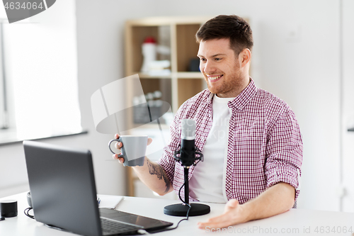 Image of blogger with laptop and microphone audio blogging