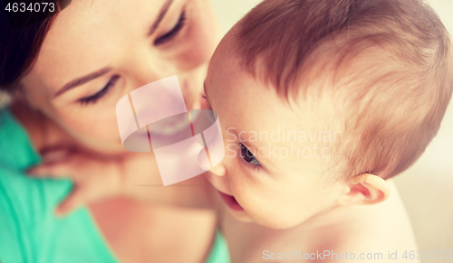 Image of happy young mother with little baby at home