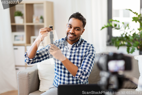 Image of male blogger with smart watch recording video blog