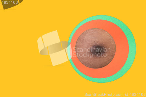 Image of Body of african-american man peeking throught circle in yellow background