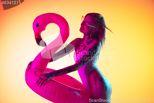 Image of Portrait of young caucasian woman on gradient yellow background with copyspace, unusual and freaky appearance