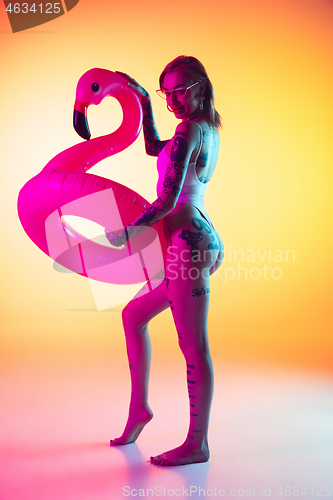 Image of Portrait of young caucasian woman on gradient yellow background with copyspace, unusual and freaky appearance