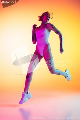 Image of Portrait of young caucasian woman on gradient yellow background with copyspace, unusual and freaky appearance