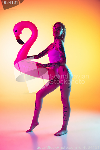 Image of Portrait of young caucasian woman on gradient yellow background with copyspace, unusual and freaky appearance