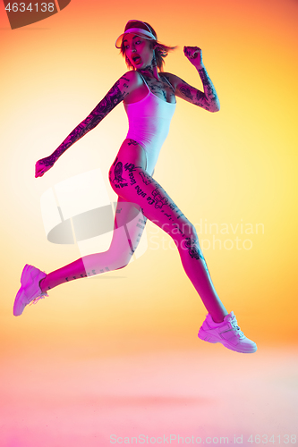 Image of Portrait of young caucasian woman on gradient yellow background with copyspace, unusual and freaky appearance