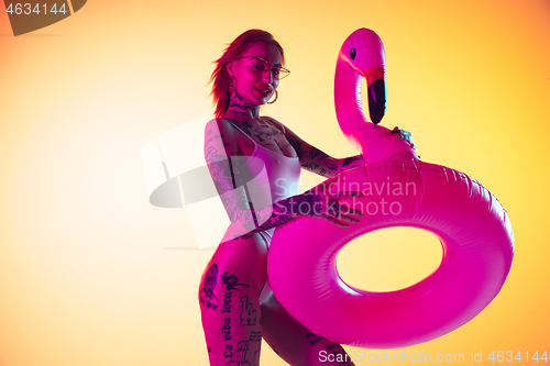 Image of Portrait of young caucasian woman on gradient yellow background with copyspace, unusual and freaky appearance