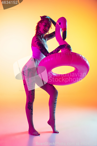 Image of Portrait of young caucasian woman on gradient yellow background with copyspace, unusual and freaky appearance