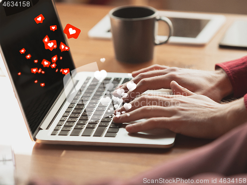 Image of Close up male hands connecting and sharing social media. Modern UI icons, communication, devices