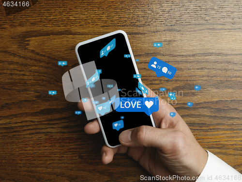 Image of Close up male hands connecting and sharing social media. Modern UI icons, communication, devices