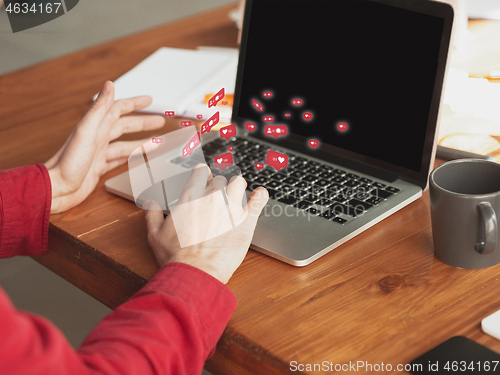 Image of Close up male hands connecting and sharing social media. Modern UI icons, communication, devices