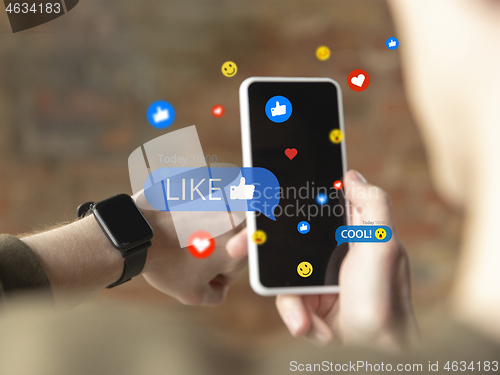 Image of Close up male hands connecting and sharing social media. Modern UI icons, communication, devices